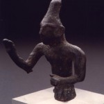 Nuraghe Flumenelongu - Alghero (SS). Bronzetto figurato di divinità benedicente con alta tiara conica (IX-VIII sec. a.C.).